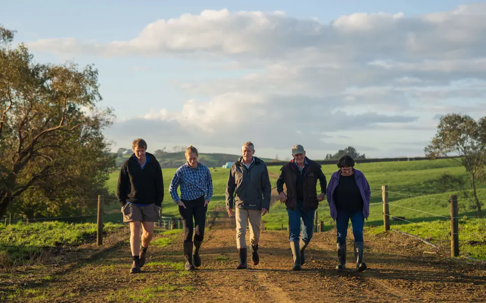 Group Of People Walking Down Track